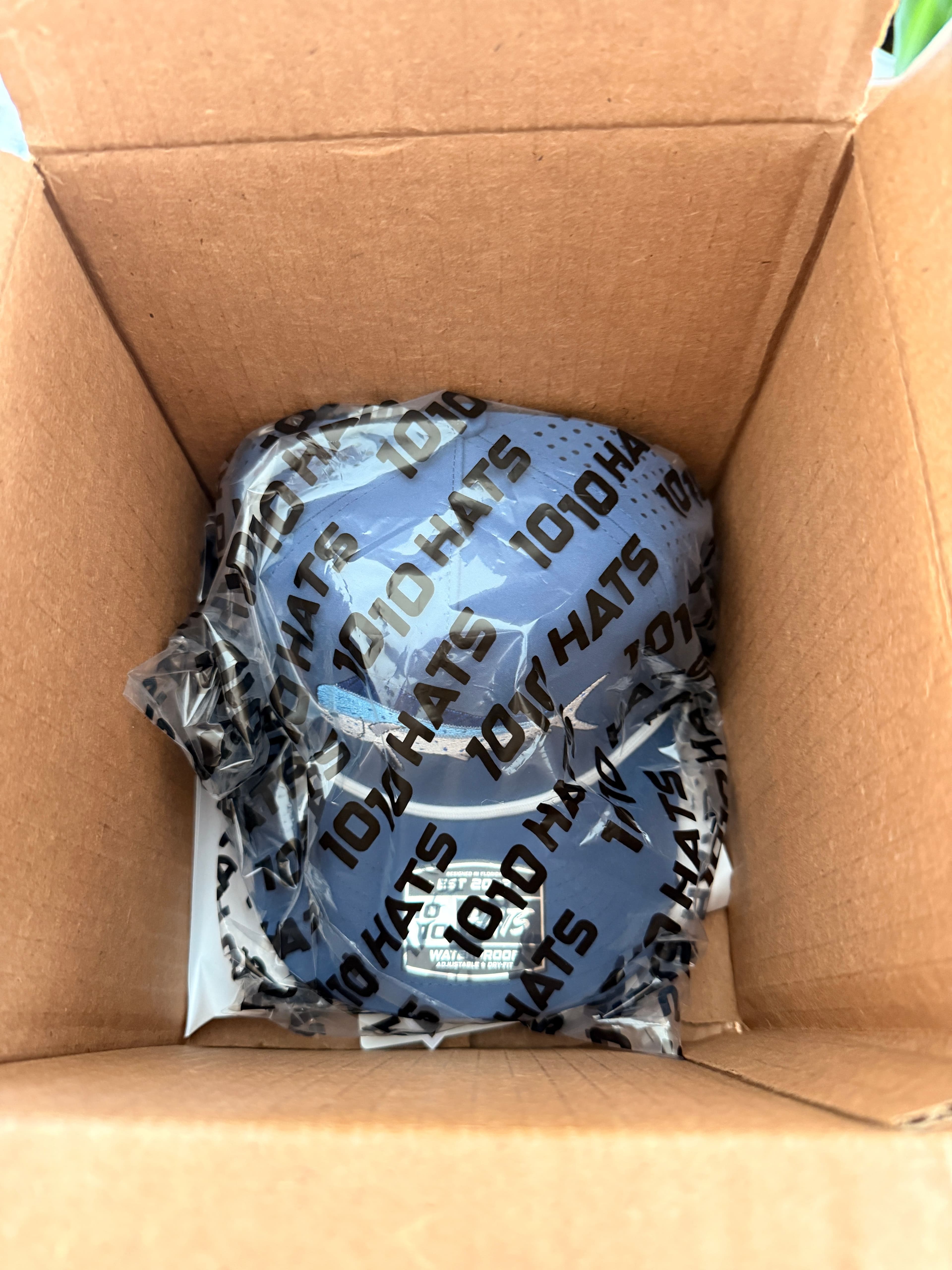 10-10 Hats Mahi Fish Hat still sealed in branded plastic packaging inside its shipping box