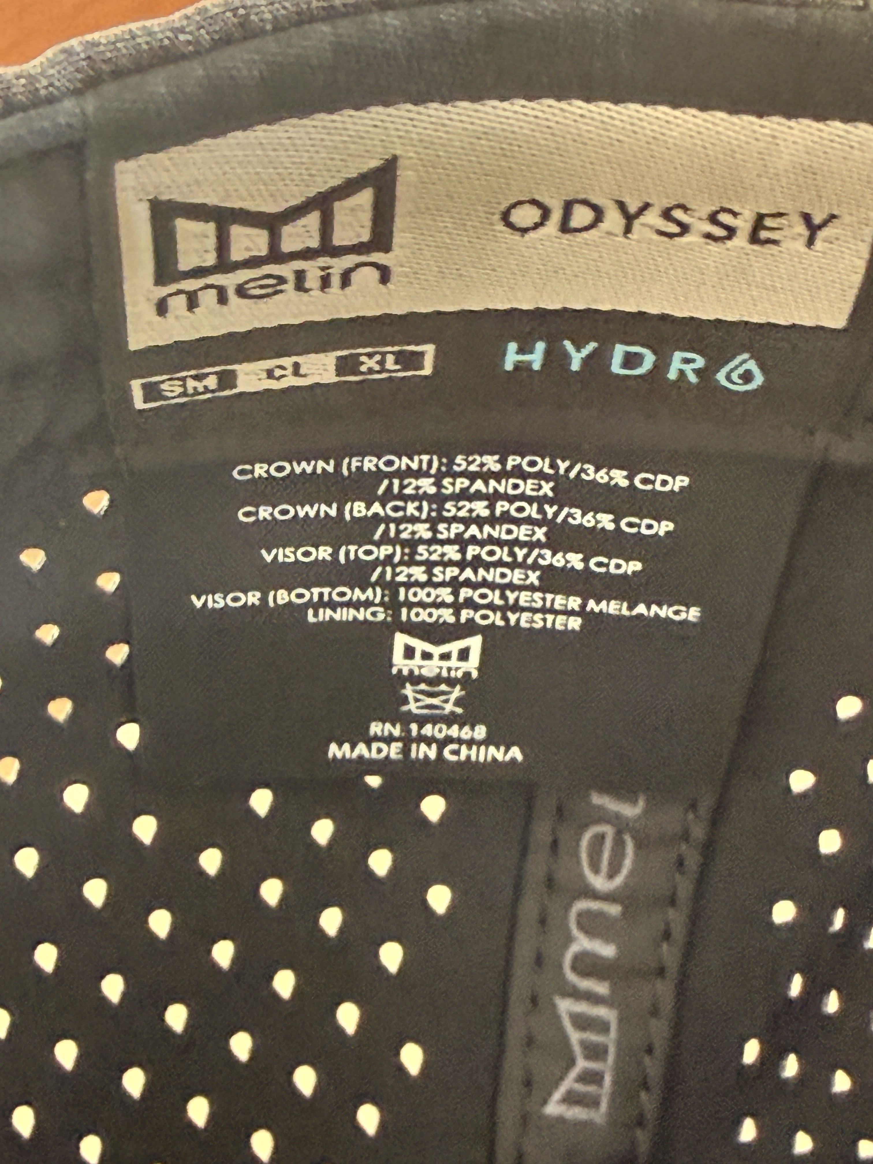 Interior tag listing the Odysea Stacked HYDRO's fabric composition and size range