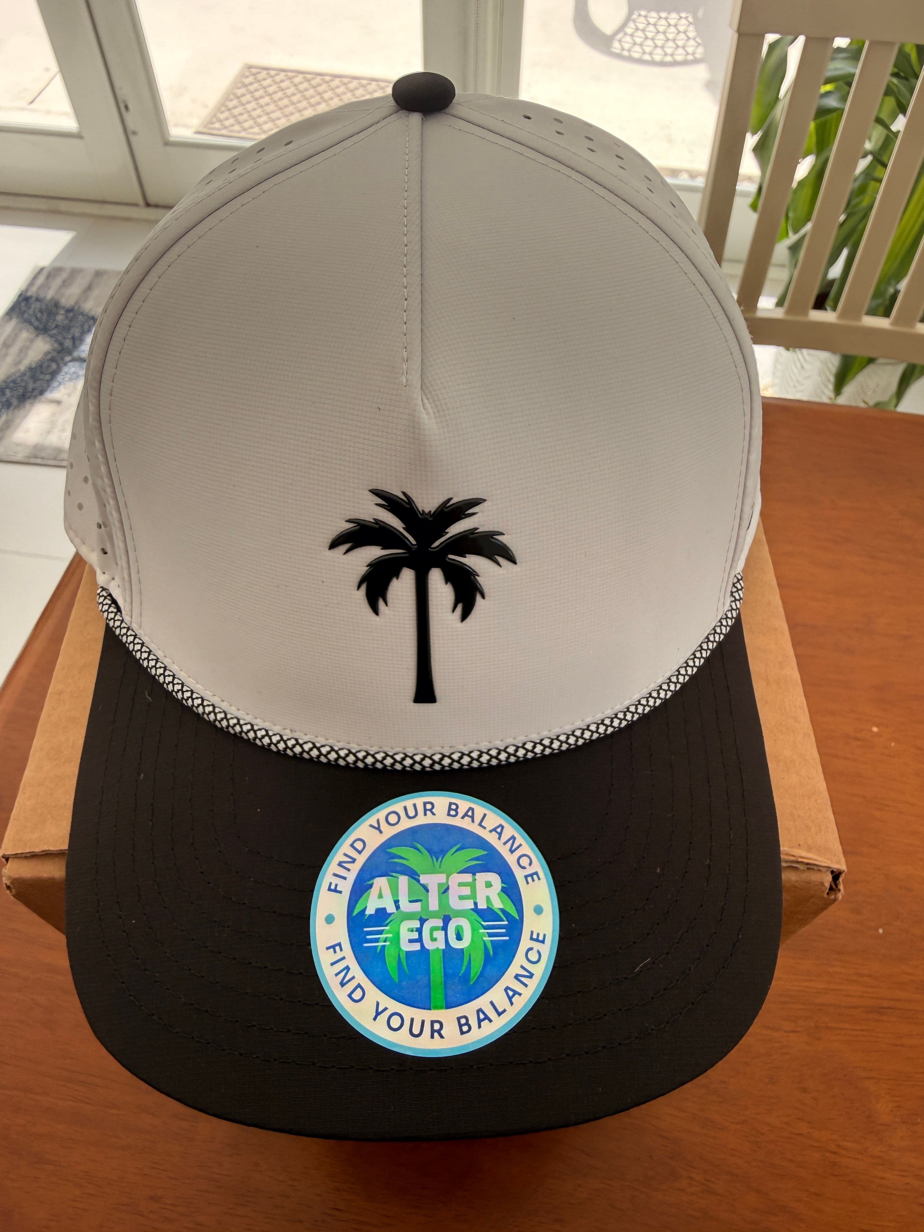 The Alter Ego Coaster Splash Classic Black White Palm hat, clean front view showing the white crown, black bill, and raised black palm tree logo