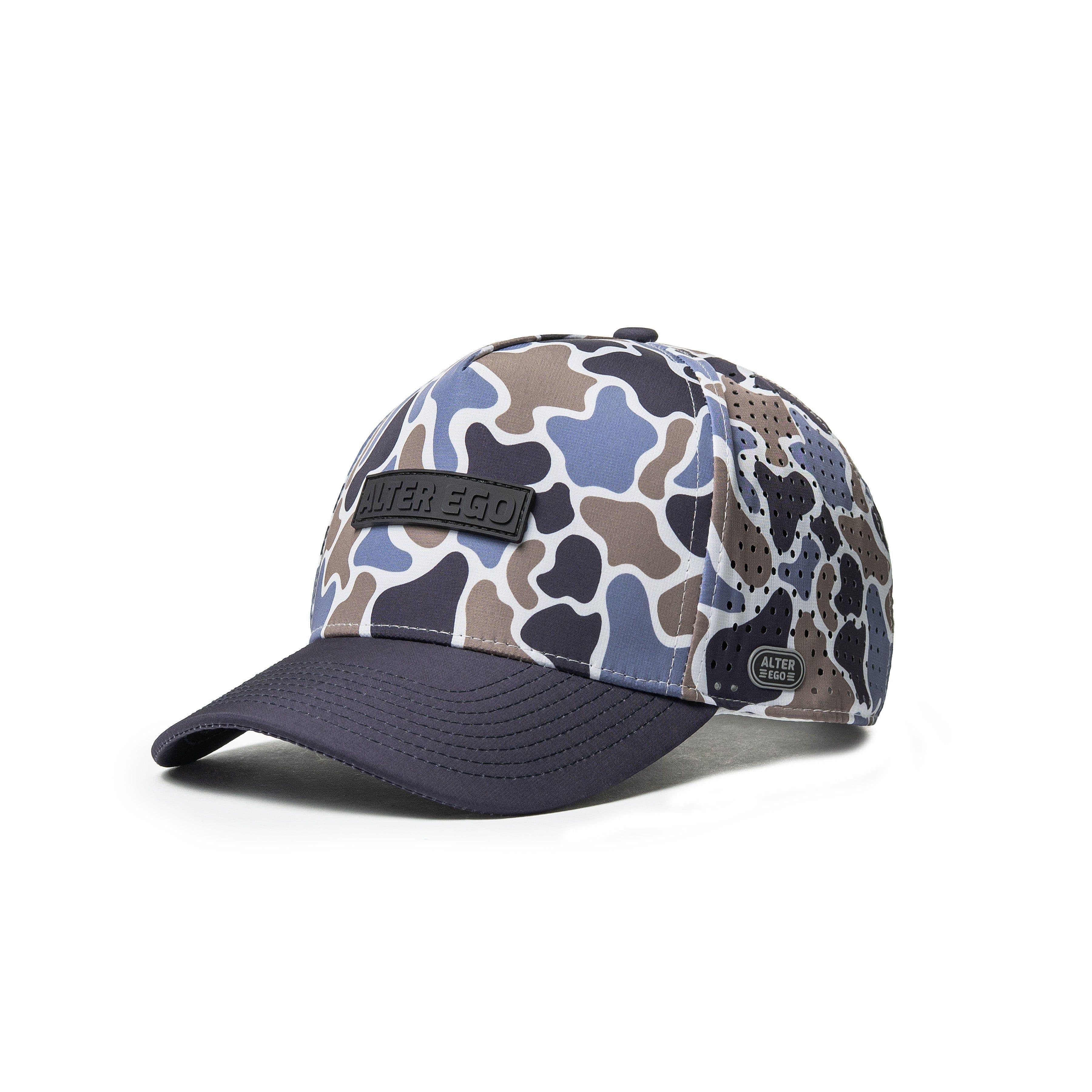 Alter Ego Running Coaster Splash Coastal Duck Camo hat, front three-quarter view, showing the multi-tone duck-camo crown, laser-perforated side panel, and navy bill