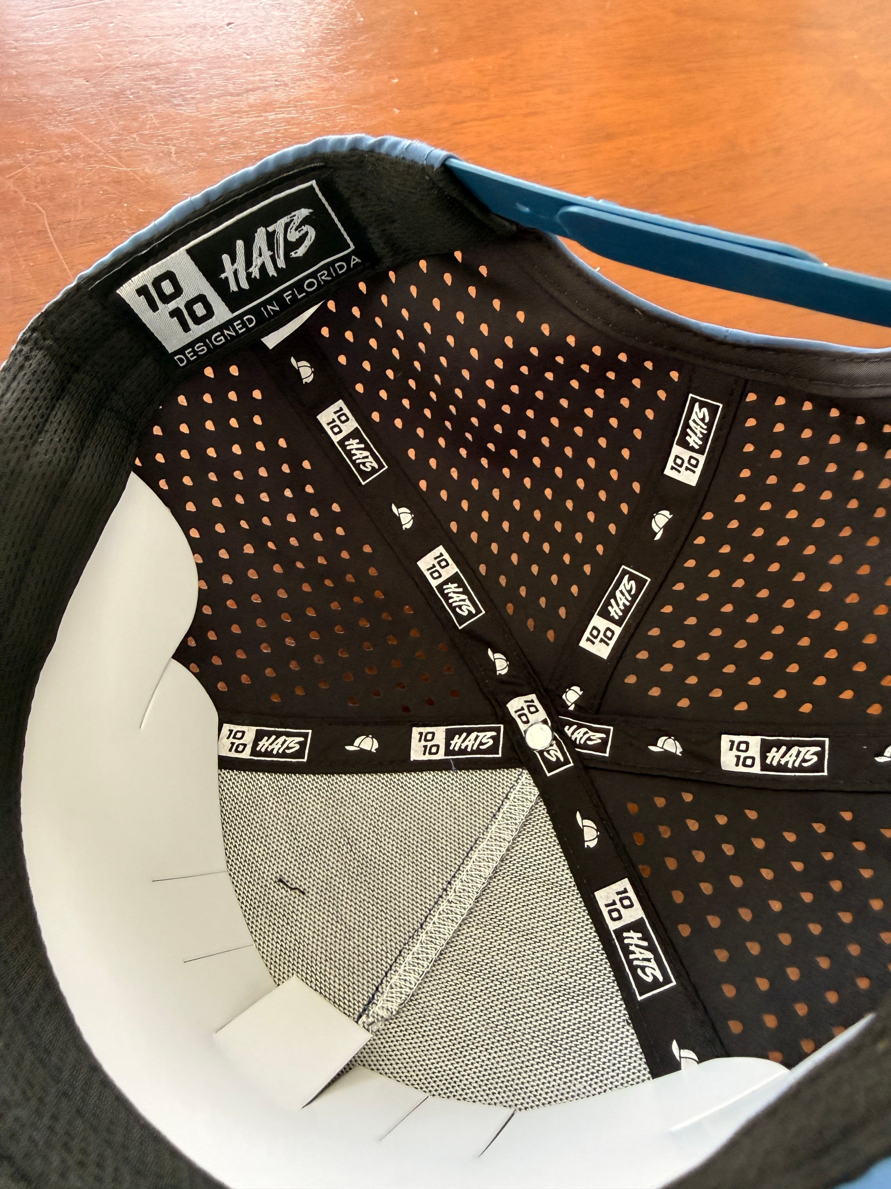Interior of the 10-10 Hats Mahi Fish Hat, showing the perforated crown lining, woven sweatband, and adjustable snapback closure